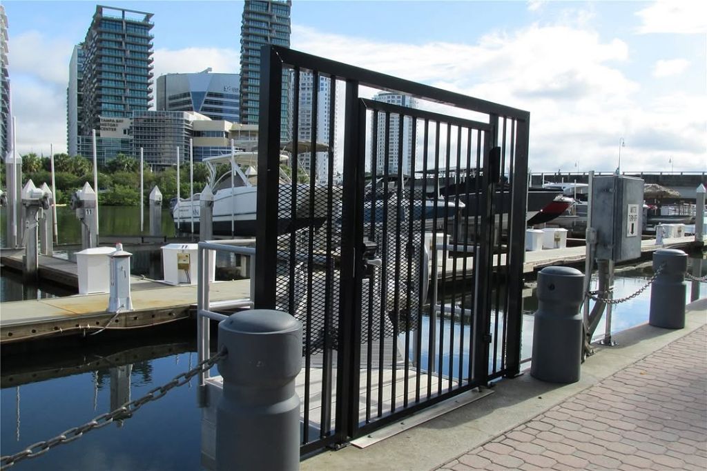 Gated security entrance to Crimson Harbour Marina Tampa FL — Tampa Bay History Center visible in background